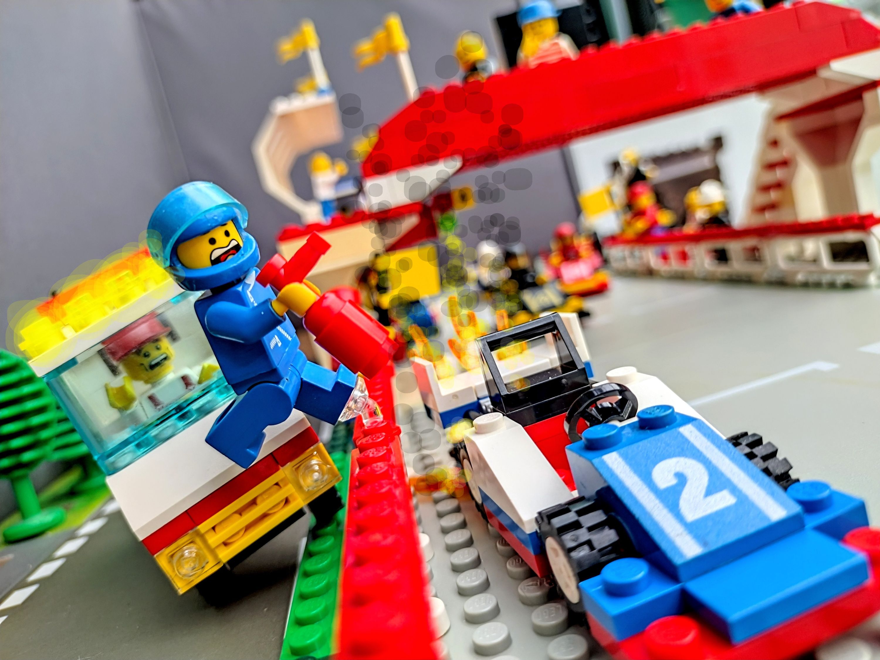 🔥 Fire!! My car!! Ow, my leg!! — a brick-built scene by @pixalixbrix, from the world Victory Lap Raceway