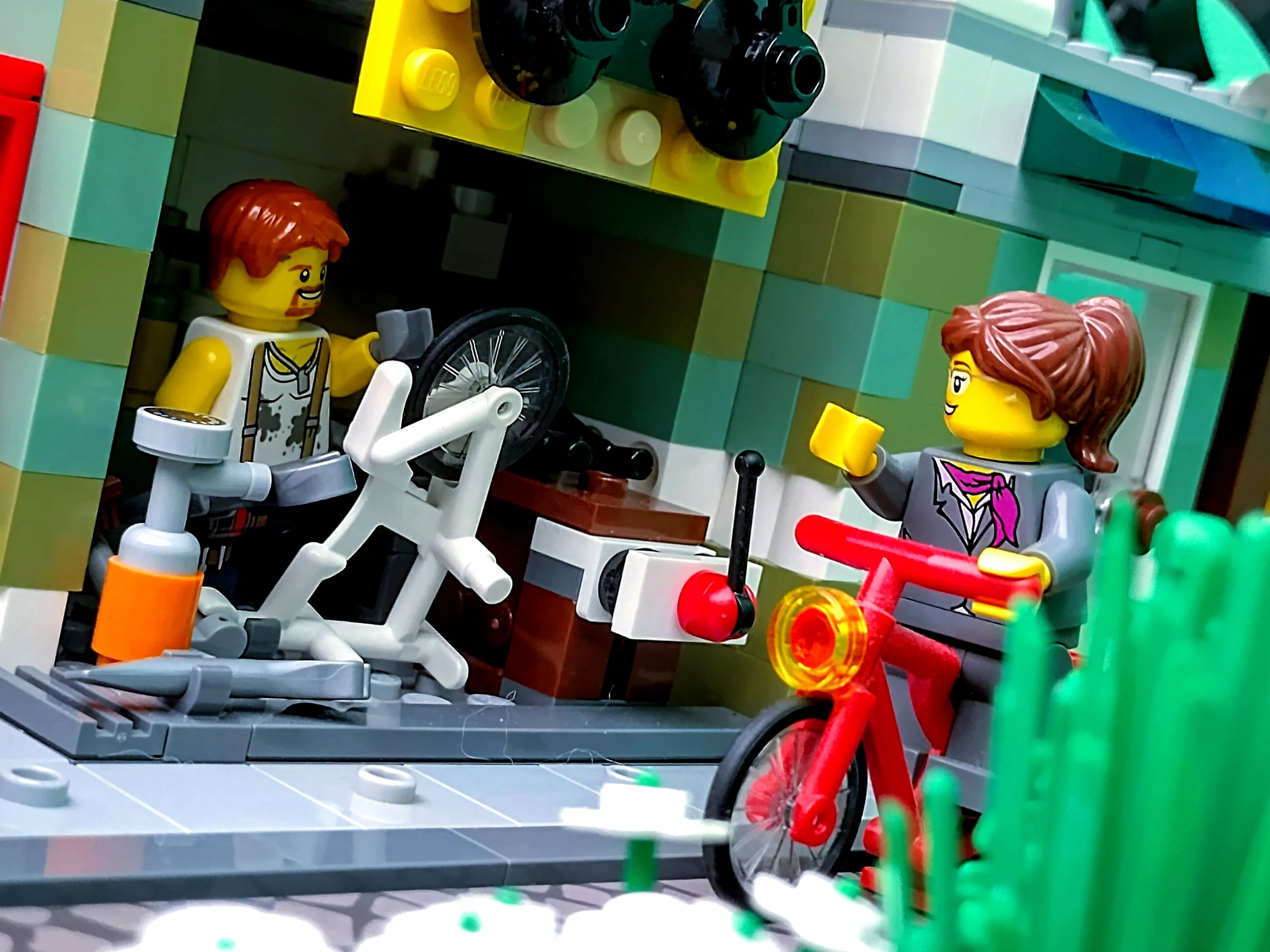 A regular and satisfied customer cycles past the bike repair garage. — a brick-built scene by @pixalixbrix, from the world…