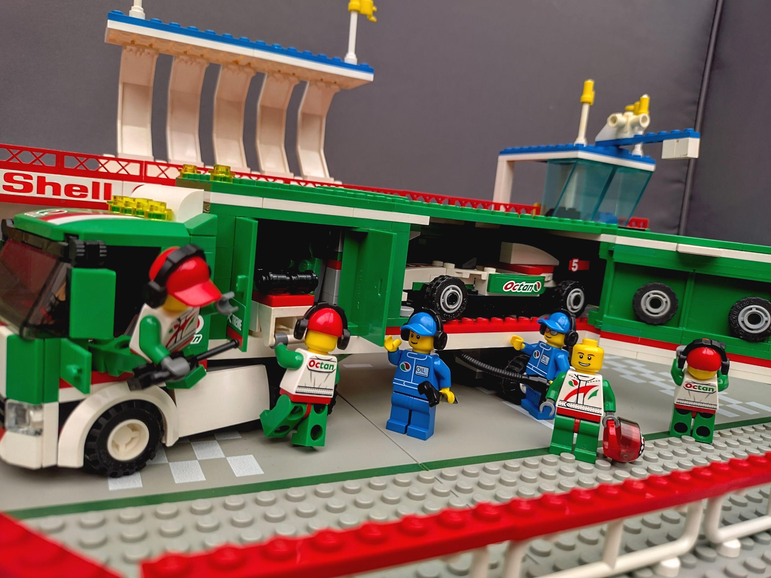 The Octan Racing team crew unpack their gear from the truck. — a brick-built scene by @pixalixbrix, from the world Victory…